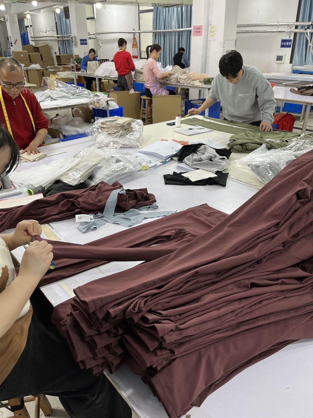 Fabric cutting and panel bundling at Huaxing Apparel factory in Dongguan, China