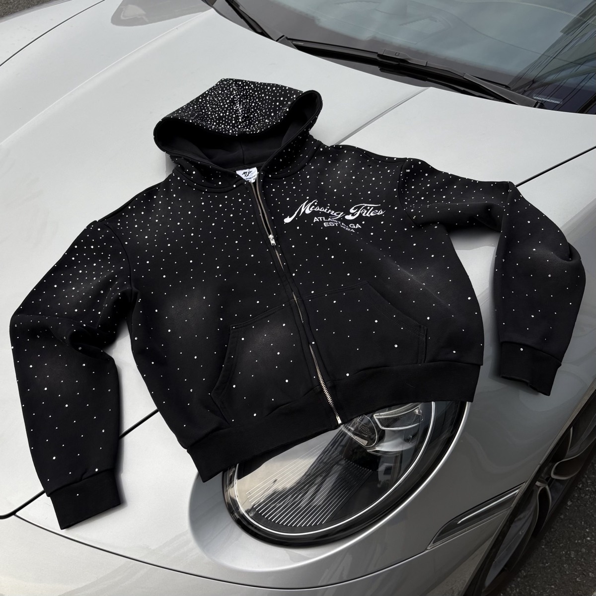 Custom rhinestone zip-up hoodie manufactured by Huaxing Apparel