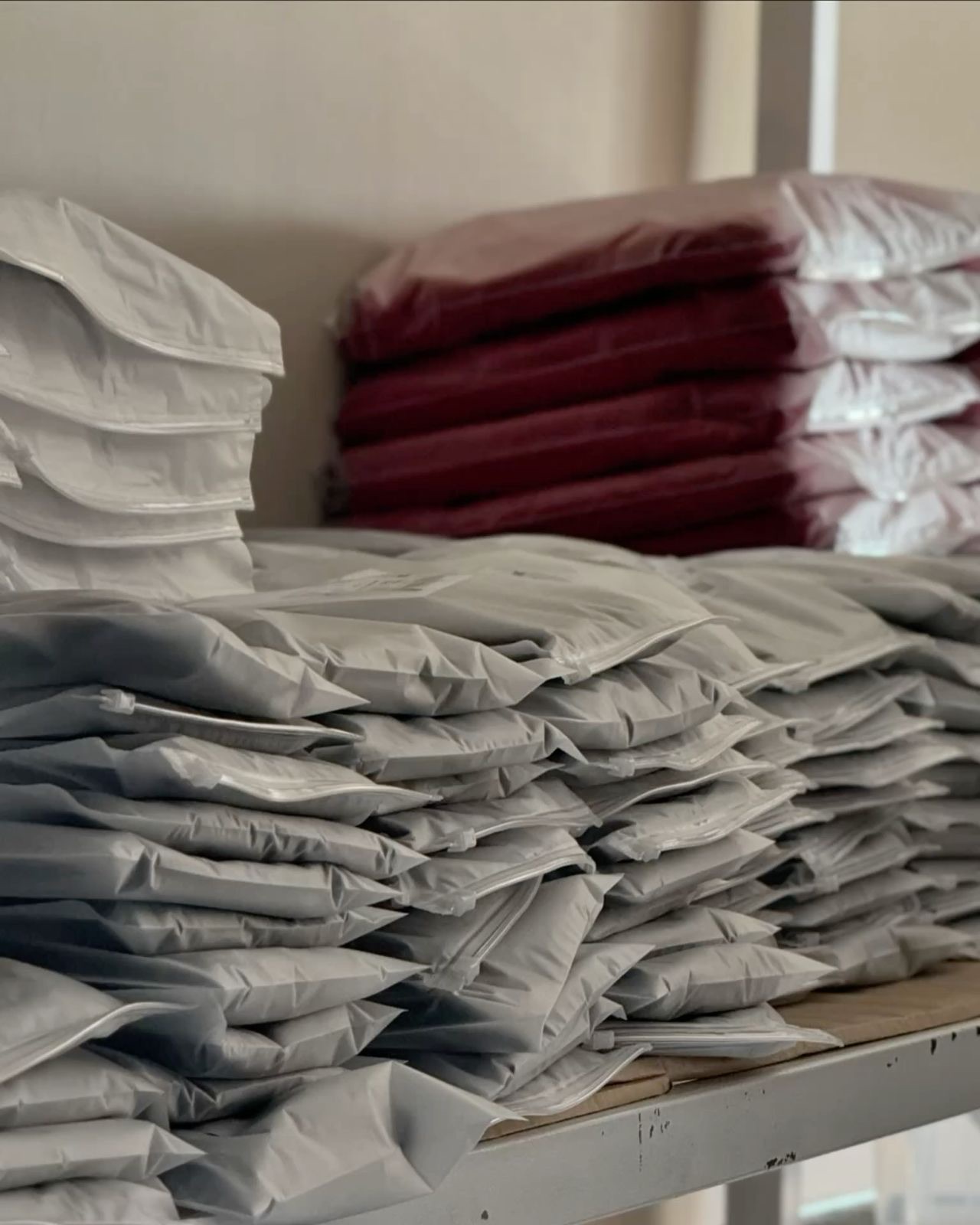 Folded small-batch custom garments ready for packing at Huaxing Apparel